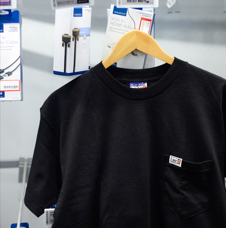 Officially licensed JAZ 1GB black pocket t-shirt, front view with chest pocket and brand logo
